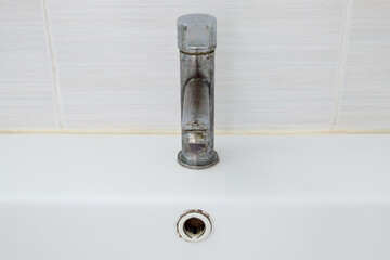 Rusty Metal Faucet with Peeling Chrome.