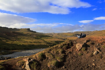 Backpack in the landscape near the Steinbogafoss river on southern Iceland