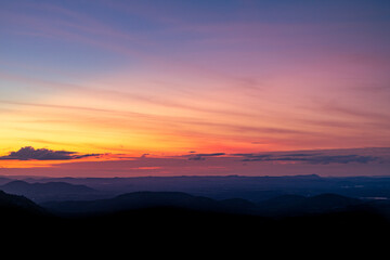 Colorful Twilight Sky Over Rolling Hills Landscape.