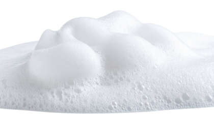 White foam with numerous small bubbles, creating a soft, airy, and frothy texture.