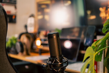 A warm and cozy desk setup featuring triple monitors, notebook, microphone, and green plants, styled in a minimalist Japanese aesthetic for creative work.