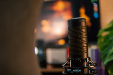 A warm and cozy desk setup featuring triple monitors, notebook, microphone, and green plants, styled in a minimalist Japanese aesthetic for creative work.