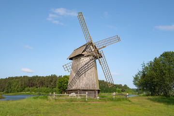 An old wooden mill in a sunny June landscape. Mikhailovskoye estate. Pushkinskie Gory, Russia