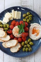 Appetizer with feta cheese, olives, tomato and bread