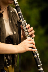 Young Musician Playing Clarinet Outdoors in Natural Light

