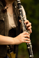 Young Musician Playing Clarinet Outdoors in Natural Light

