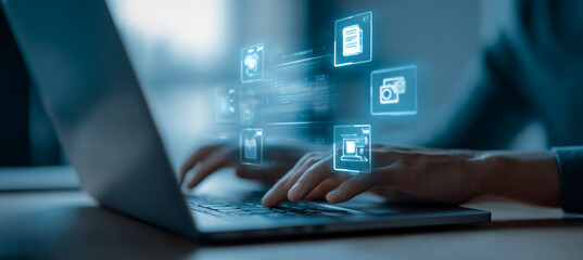 Person types on laptop with glowing data icons. Digitalization concept for business, web, marketing, design.
