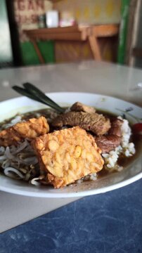 Rawon is a traditional Indonesian beef soup with black keluak broth, rich aroma, and tender meat, usually served with rice, egg, and sambal