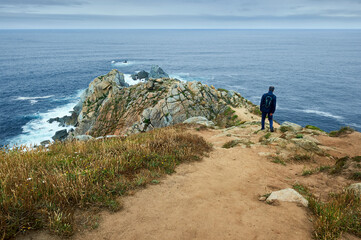 A hiker approaches the last rocks at Estaca de Bares cape.
