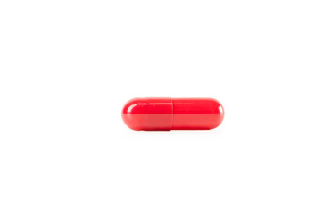 Red pill capsule, a macro of a common medical drug for healthcare and treatment. A single dose of medicine or a vitamin supplement. isolated on white background with clipping path.