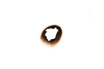 Burnt hole in a sheet of paper, creating a frame to reveal a secret or confidential information....