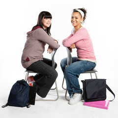 Teenagers: Best Friends. Friendly smiles to the camera from a pair of teenage school girl friends....