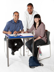 Teenagers: Teacher and Students. Bright smiles to the camera from a pair of late teenage school...