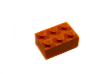 Fototapeta premium Miercurea Ciuc, Romania- 17 July 2025: Orange Lego brick on white background.