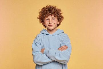Confident Boy with Arms Crossed Smiles.