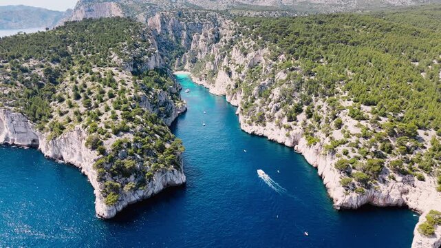 Aerial view of National Park Calanques with rocky coastal landscape and boats cruising along the shore
