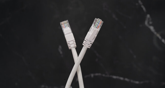 ethernet internet cat6 lan white cable close up shot on dark theme background 