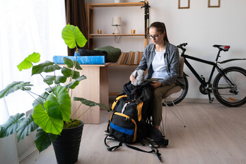 Backpacker preparing to trip. check the checklist for journey. Travel, hiking and vacation concept.