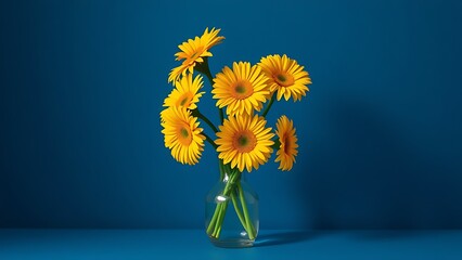 Vibrant yellow gerbera flowers in a simple vase, creating a striking contrast against a deep blue backdrop.