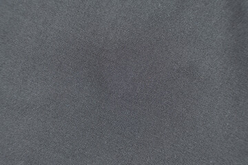 Fabric composed of wool and polyester, macro texture, abstract black fabric background.