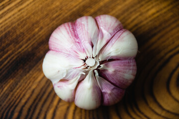 Cloves of unpeeled garlic close-up on a dark wooden table