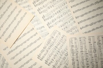 Fototapeta premium Sheets with musical notes as background, top view