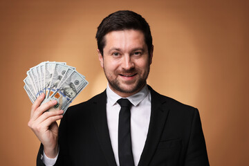Happy greedy banker with dollar banknotes on golden background