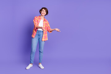 Full body portrait of pretty young lady arms show empty space wear shirt isolated on purple color background