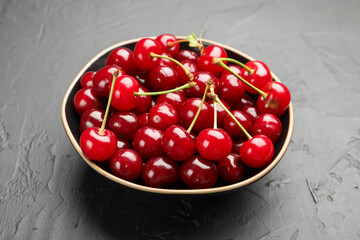 Fresh ripe cherries on black table, closeup