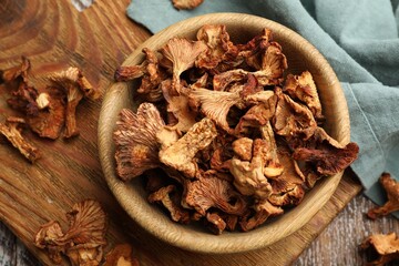 Dried chanterelle mushrooms on wooden table, flat lay