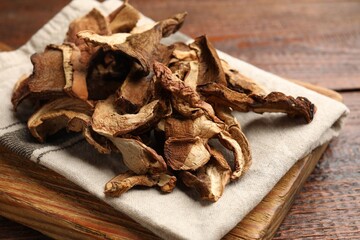 Dried chanterelle mushrooms on wooden table, closeup