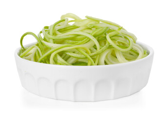 Raw squash noodles in bowl isolated on white. Vegetarian dish
