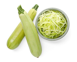 Raw squash noodles and fresh vegetables isolated on white, top view. Vegetarian dish