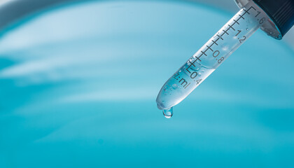 Blue water drop of science experiment,Test tubes with blue liquid water samples and pipette over...