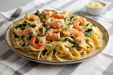 Homemade Creamy One-Pot Spinach Shrimp Pasta on a Plate, side view.