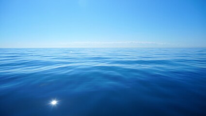 Fototapeta premium Blue sea meeting blue sky under soft clouds and sunlight