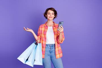 Photo of nice young girl hold phone bags empty space wear shirt isolated on violet color background