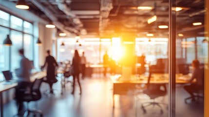 Blurred Figures Collaborating in a Sunset Workspace 