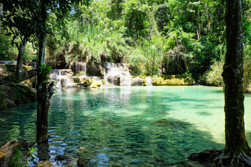 Naklejka premium Most magnificent and breathtaking nature of Kuang Si waterfall and cascade and its green, emerald crystal clear water and lake in Luang Prabang 