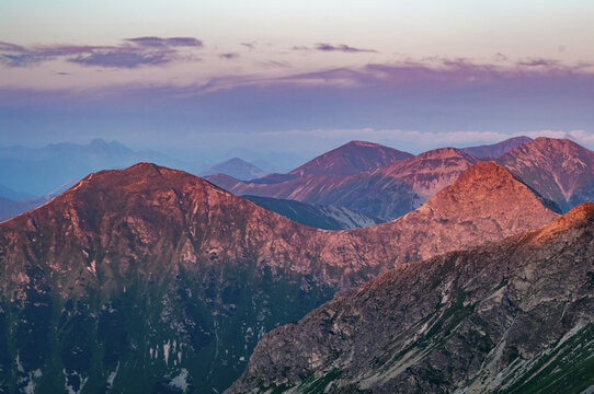 Aerial view of rugged peaks catching the fading light, their shadows deepening as dusk settles over the landscape, Jamn&Atilde;&shy;k, &Aring;&frac12;ilina Region, Slovakia.