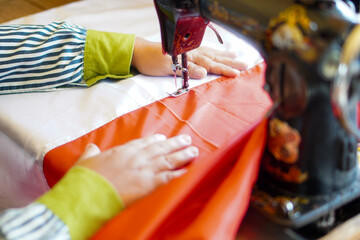 A woman sews the red and white flag, Indonesia's national flag, using a sewing machine. The theme is celebrating independence on August 17, 1945.