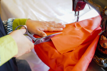 The process of cutting cloth to sew the red and white flag, Indonesia's national flag. The theme is celebrating independence on August 17, 1945.