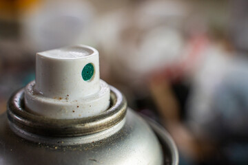 Aerosol can nozzle, close-up on blurred background