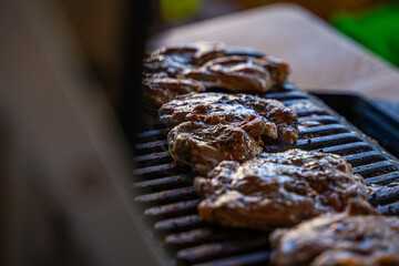 Pork steak being grilled on an electric grill, close-up