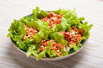 Lettuce wraps filled with a savory mixture of minced meat, herbs, and spices, creating a flavorful...