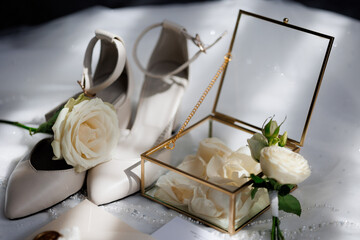 Elegant wedding shoes and floral display create a romantic bridal setting