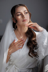 Bridal portrait of a woman with elegant hairstyle and makeup in soft natural light
