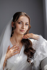 Bride preparing for her wedding day with elegance and grace in a bright setting