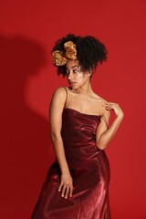 Fashionable portrait of beautiful Brazilian woman in stylish outfit on red background
