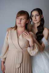 Mother and daughter celebrate a special moment in elegant attire indoors